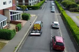 The Stream EM, Old Faithful, being towed by a Macleod Simmonds van through a residential area collecting road GPR scan data.