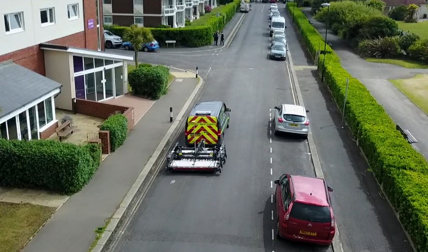 The Stream EM, Old Faithful, being towed by a Macleod Simmonds van through a residential area collecting road GPR scan data.